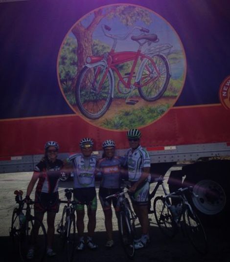 Heather, Mark, Sumi and Steve pose in front of an appropriate backdrop